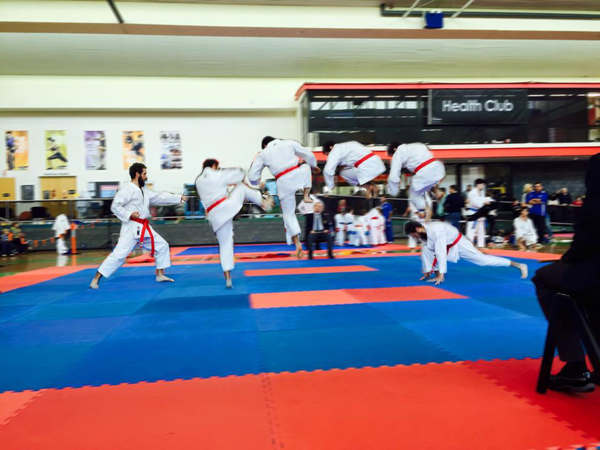 A TKA student mid-jump during kumite training